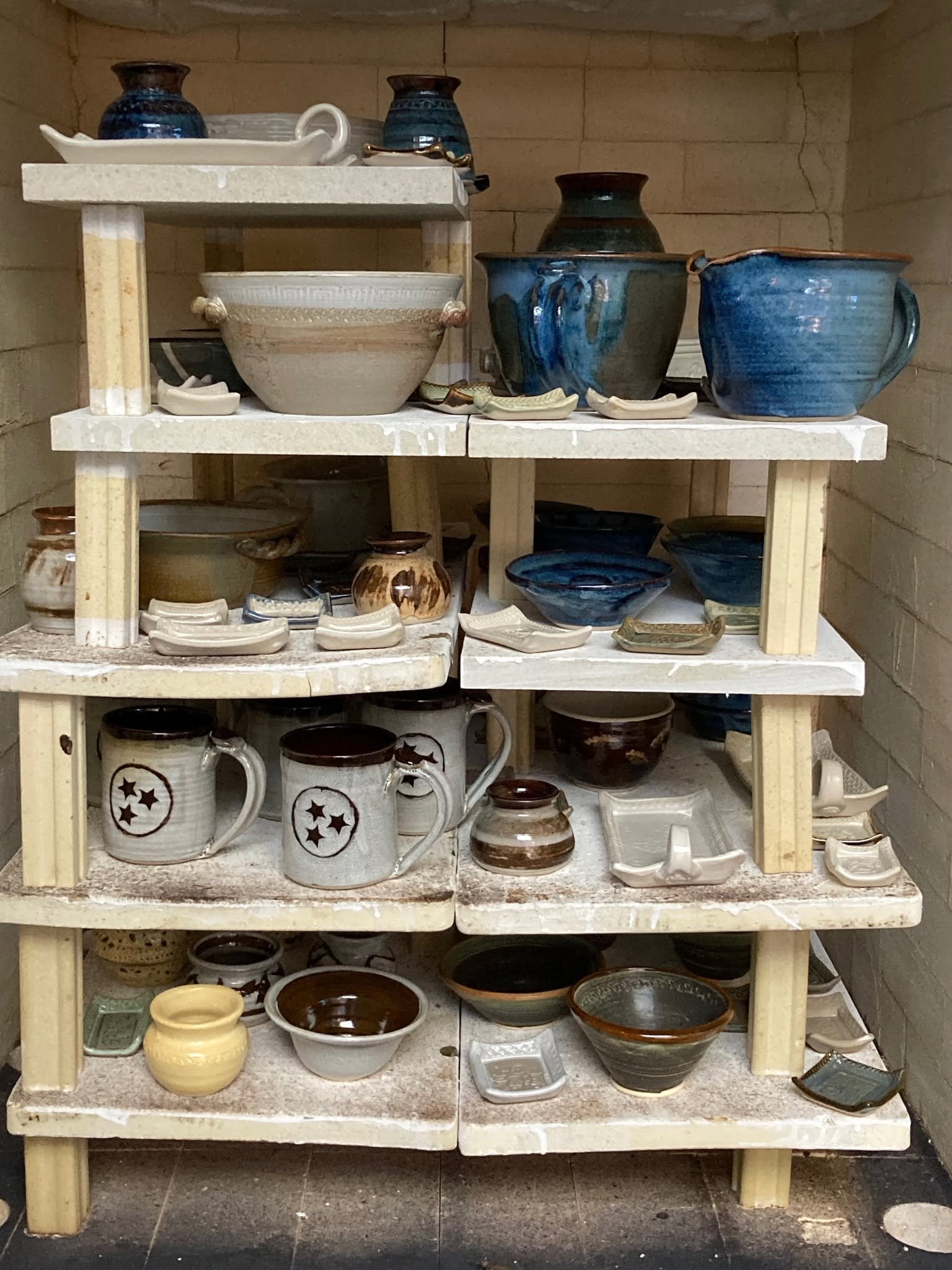 Shelves filled with Woodland Gallery pottery